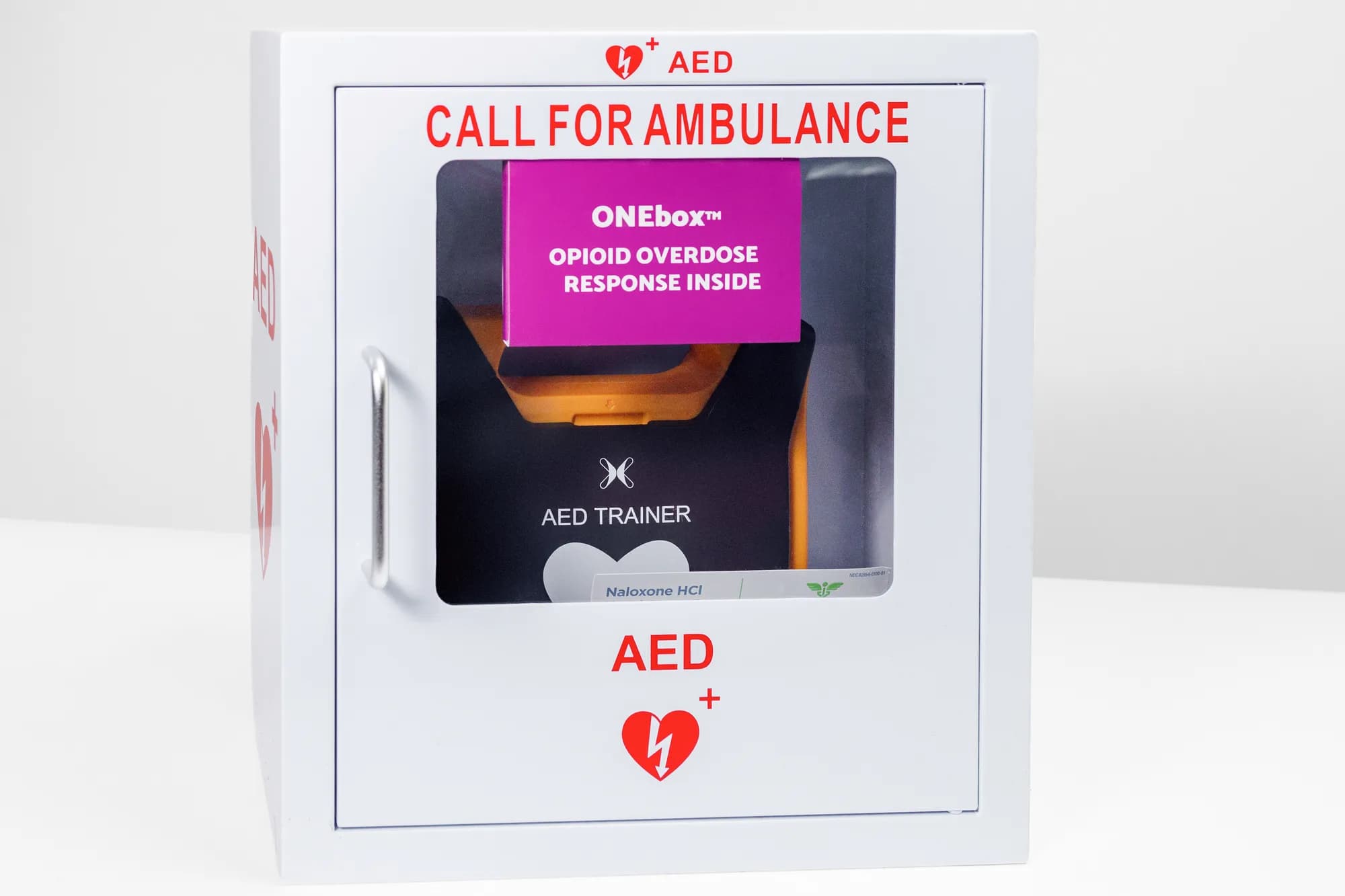 AED wall cabinet, closed with Call For Ambulance signage